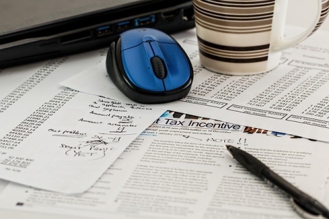 tax forms, computer and mouse, coffee cup